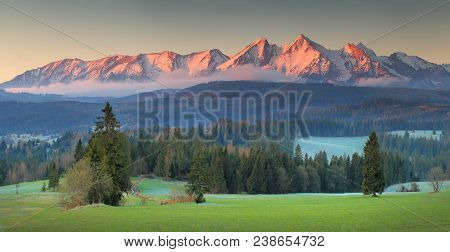 Panoramic View Of Tatra Mounains.tatra Mountains In The Morning. Beautiful Green Valley At Snowy Mou