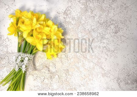 Narcissus Bouguet With Lace Laying On The Silver Grey Cement Background With Copy Space