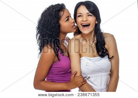 Two Best Friend Girls Wispering A Secret. Isolated On White Background.