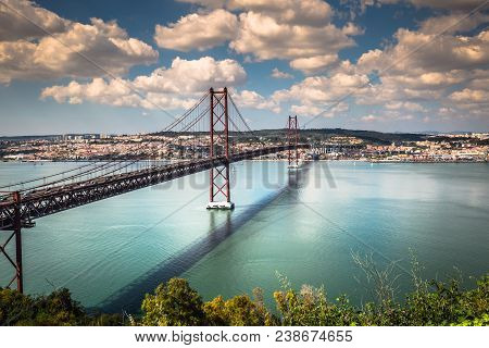 The 25 De Abril Bridge Is A Bridge Connecting The City Of Lisbon To The Municipality Of Almada On Th
