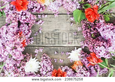 Purple Spring Lilac Frame Over Rustic Textured Wooden Board Isolated