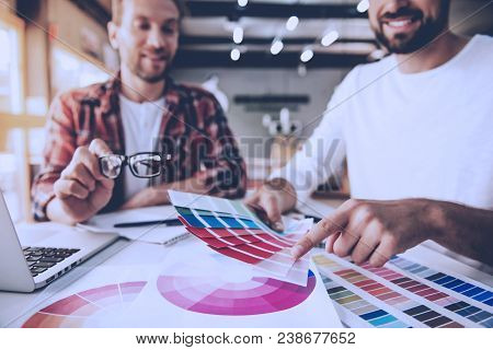 Cropped Image Of Handsome Designers In Casual Clothes Discussing Colors And Smiling While Working In