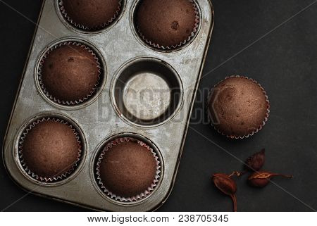 Just Baked Homebaked Chocolate Muffins For Dessert With Colored Conffeti. Black Background.