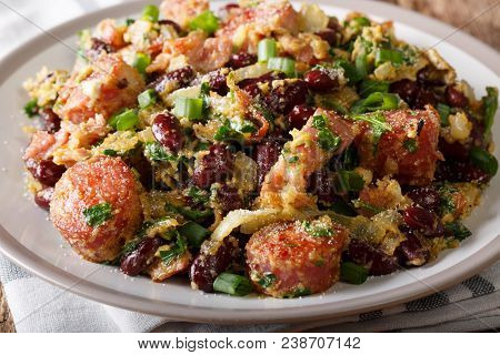 Brazilian Fried Feijao Tropeiro With Beans, Sausage And Bacon Close-up On A Plate. Horizontal