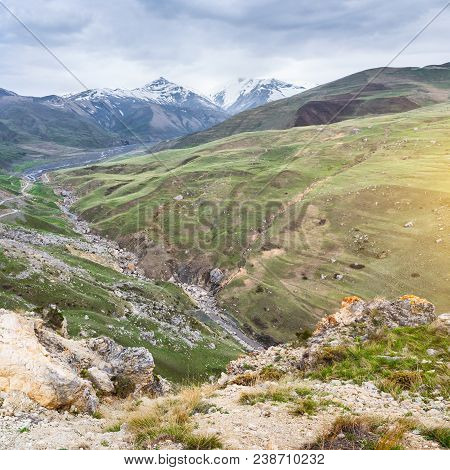 Beautiful View Of The Snow-covered And Vegetated Caucasus Mountains