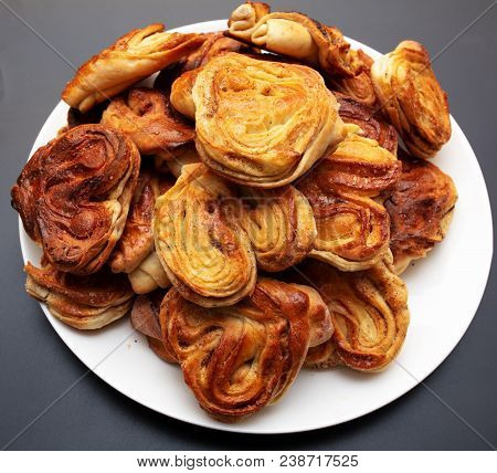 Buns With Raisins And Jam On A Black Background .