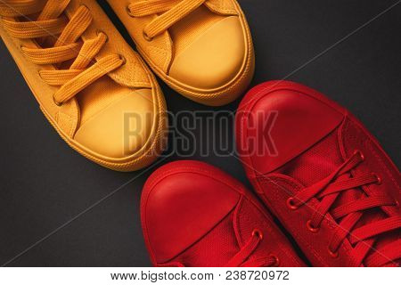 Young Adult People On A Love Date, Conceptual Image. Top View Of Two Pair Of Casual Sneakers, Yellow