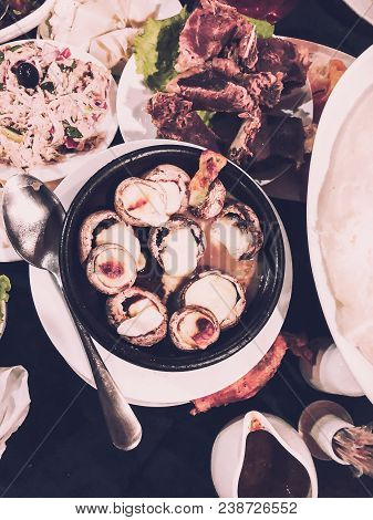 Fried Mushrooms In A Creamy Sauce And Cheese Cooked In A Frying Pan.
