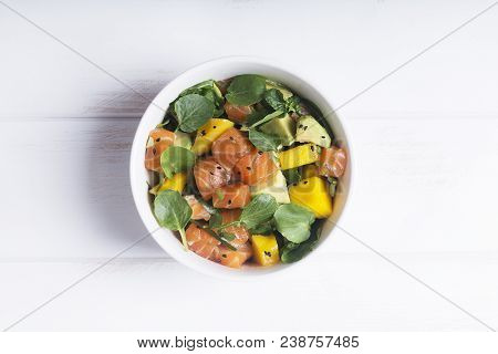 Hawaiian Poke Salad With Salmon, Avocado And Vegetables In A Bowl On A Rustic Background. Good Dieti