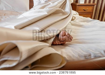 Cropped Image Of Female Feet On The Bed. Wedding Morning