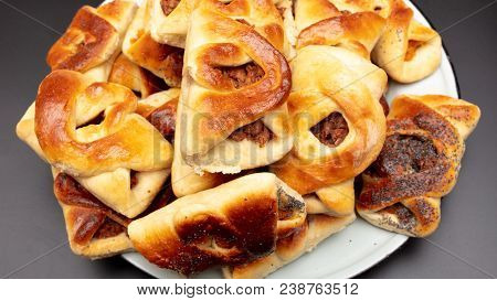 Buns With Raisins And Jam On A Black Background .