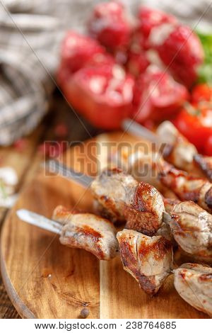 Shish Kebab From Pork Closeup. Juicy Meat Cooked On Open Fire And Ripe Pomegranate. Rustic.