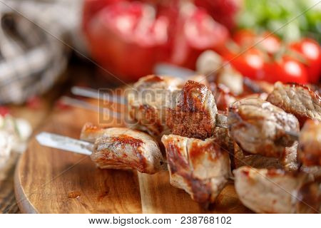 Shish Kebab From Pork Closeup. Juicy Appetizing Meat Cooked On An Open Fire. Rustic.