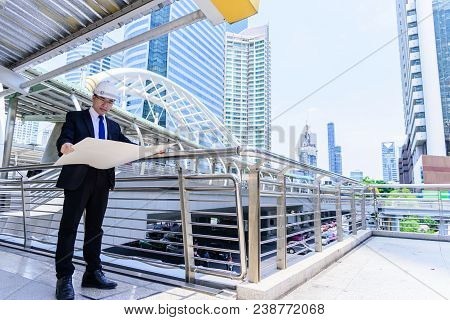 Asian Business And Engineer Man Has Planning And Working For Design Buiding And City.