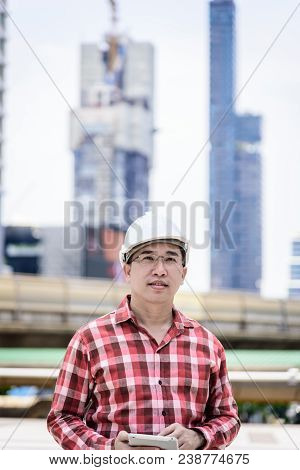 Asian Business And Engineer Man With Red Scott Shirt Has Planning And Working For Design Buiding And