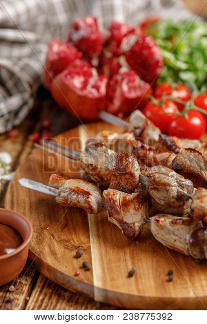 Meat On Skewers Cooked On An Open Fire. Still Life With Textiles On A Wooden Background.