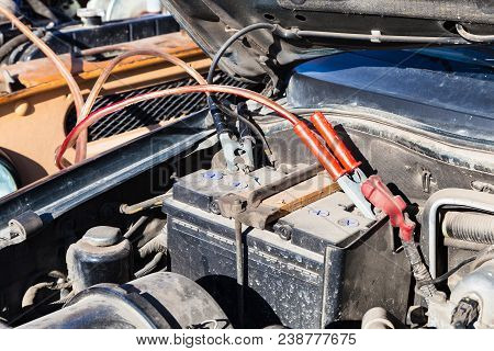 Jump Start A Flat Car Battery With Another Vehicle And Jumper Leads Outdoor