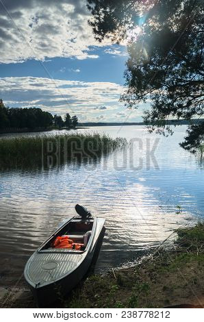 Fishers' Motorboat, Moored To The Riparian Forest Of The Lake Seliger Under The Blinding Sunlight, R