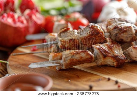 Tasty And Juicy Kebabs From Pork. Still Life With Textiles On A Wooden Background.