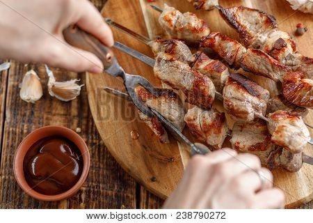 Rustic Still Life. Juicy Pork Meat Is Cut With A Knife And Fork. Appetizing Shish Kebabs And Sauce T