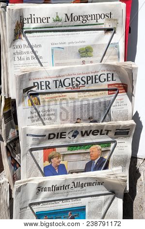 Berlin - Apr 28, 2018: Newspaper Stand With Various German Newspapers And Angela Merkel And Donald T