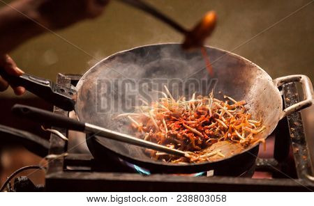Thai Asian Street Fast Food In Hot Pan, Pad Thai, Or Phad Thai Is A Stir Fried Rice Noodle Dish Comm