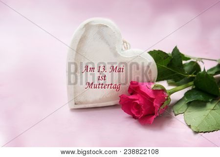 Heart Of Wood And A Rose On A Pink Background,  German Text Am 13. Mai Ist Muttertag, That Means May