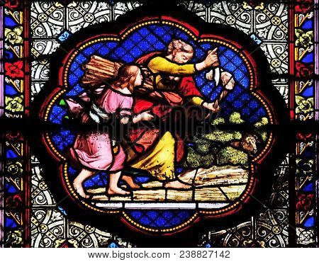 PARIS, FRANCE - JANUARY 05: Isaac carrying the wood of the sacrifice, prefiguration of the carrying of the Cross, stained glass in the Basilica of Saint Clotilde in Paris, France on January 05, 2018.