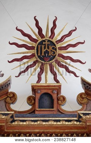 VUKOVOJ, CROATIA - OCTOBER 08: IHS sign on the main altar in the chapel of St. Wolfgang in Vukovoj, Croatia on October 08, 2016.