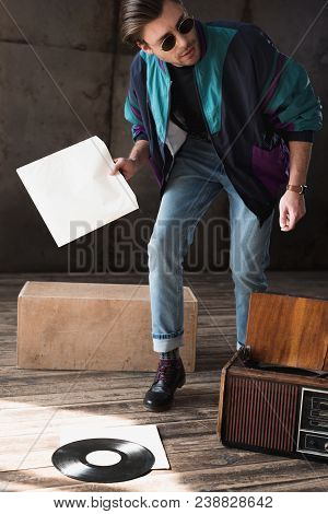 Handsome Young Man In Vintage Windcheater With Vinyl Record Player