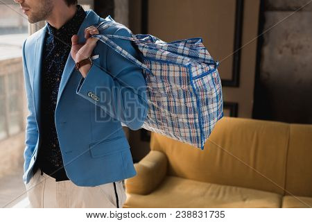 Cropped Shot Of Young Man With Vintage Zippered Duffle Bag