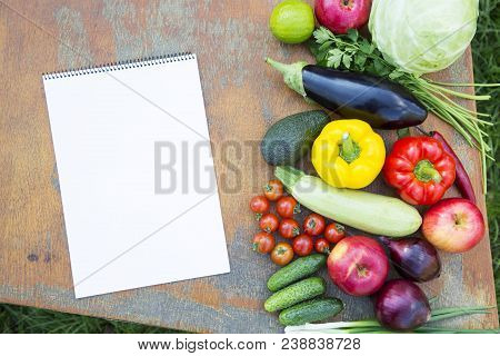 Set Of Fresh Organic Vegetables And Fruits On Rustic Wooden Table And Notebook. Diet Plan. Healthy F