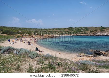 Bozcaada, Turkey - April 29, 2018; Tourists Are Sunbathing On Aquarium Beach, Bozcaada Island