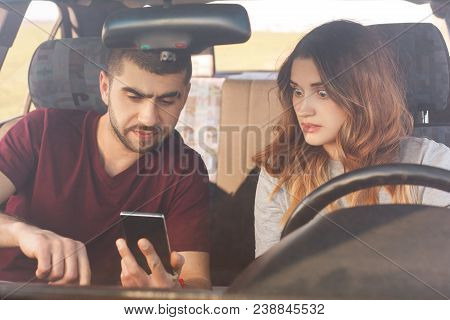 Surprised Female Looks At Smart Phone, Realize Togeher With Husband Thay They Lost Way, Sit Together