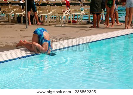 Humorous image of a girl in bathing suit cooling her head  in a 