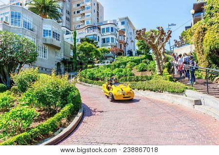 San Francisco - Apr 2, 2018: Tourists Drive Down Crooked Lombard Street On A Gocar, A Scooter Create
