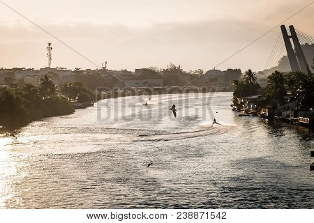 Marapendi Lagoon Seen From Above With Houses On The Hill During Sunset, Golden Light. Jet Skis Are R