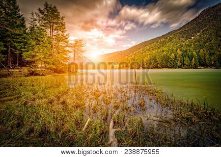dobbiaco lake at sunset, south tyrol alps in italy