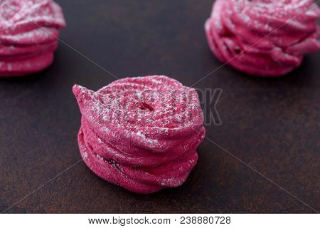 Close-up Sweet Meringues Cookies On Brown Stone Background