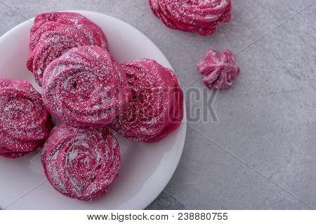 Close-up Homemade Meringues On White Plate And Gray Background