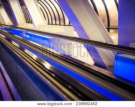 moving travolator walkway in the airport magenta neon colours toned