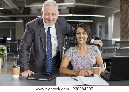 Business Portrait Of Smiling Experienced Mentor And New Hire. Positive Mature Man In Suit Posing Wit