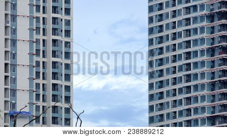 Two High Buildings Under Construction In The City With Blue Sky