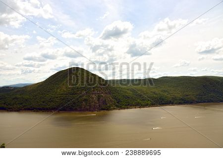 Breakneck Ridge. Green Mountain Near Body Of Water Under White Clouds