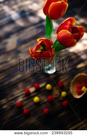 Blossoming Red Tulips On A Wooden Background With Sweets