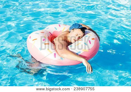 Drunk A Russian Tourist On An Inflatable Donut Swimming In The Pool.