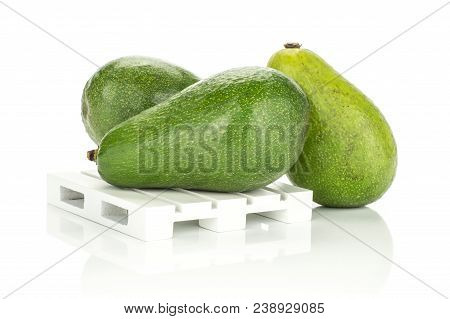 Three Green Smooth Avocado On A Wooden Pallet Isolated On White Background Ripe Shiny Bacon Variety