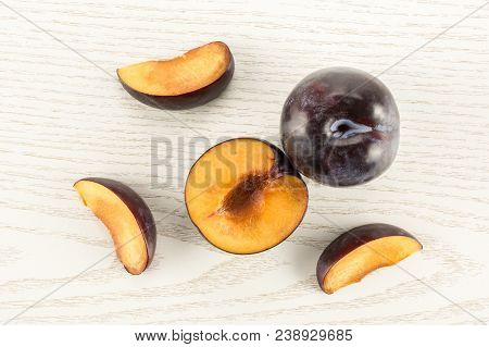 Red Blue Plums Set Table Top Isolated On Grey Wood Background One Whole One Section Half Three Slice