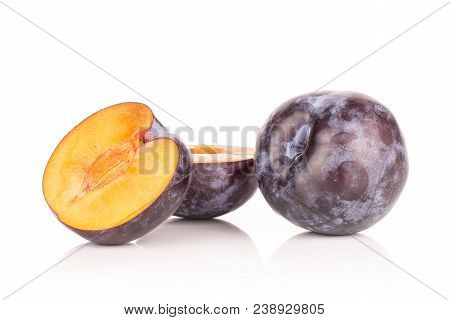 Sliced Red Blue Plum And One Whole Isolated On White Background One Cut In Two Halves