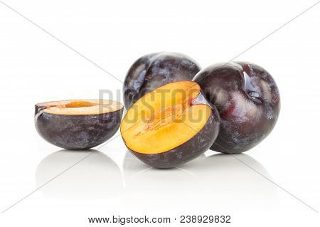 Two Red Blue Plums And Two Halves Isolated On White Background